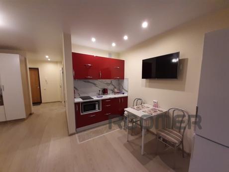 One-room studio apartment is located on the 13th floor of a 