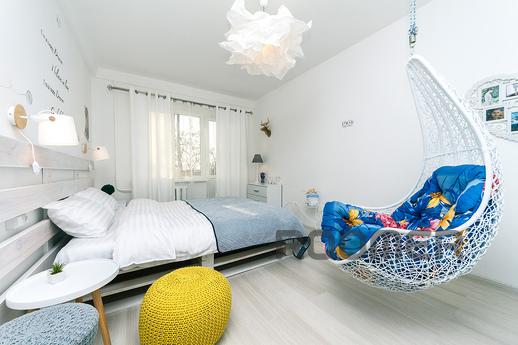 The apartment is decorated in Scandinavian style, filled wit